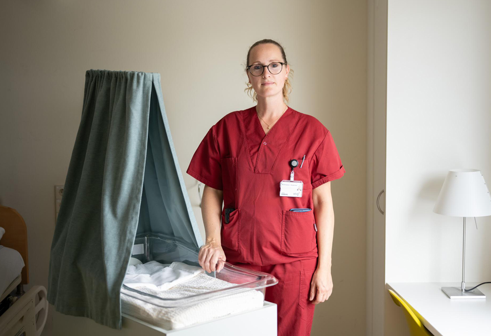 Foto van zorgverlener Maaike Bakker naast een lege wieg